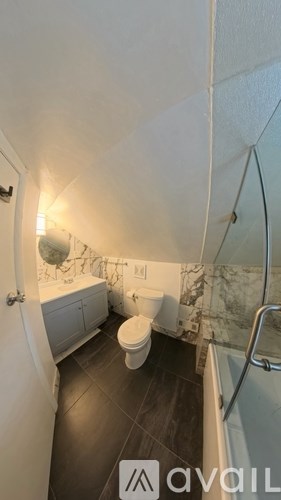 A small bathroom with a toilet and a shower.