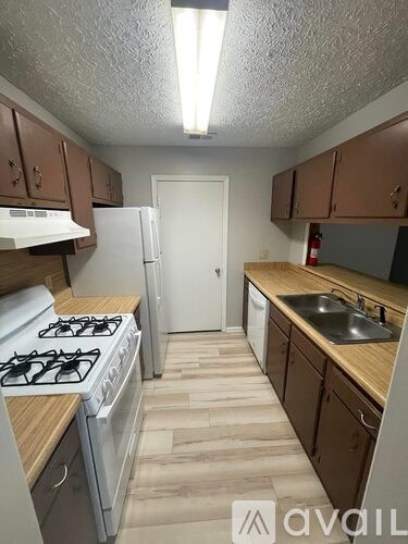 A kitchen with a white fridge and a white door.