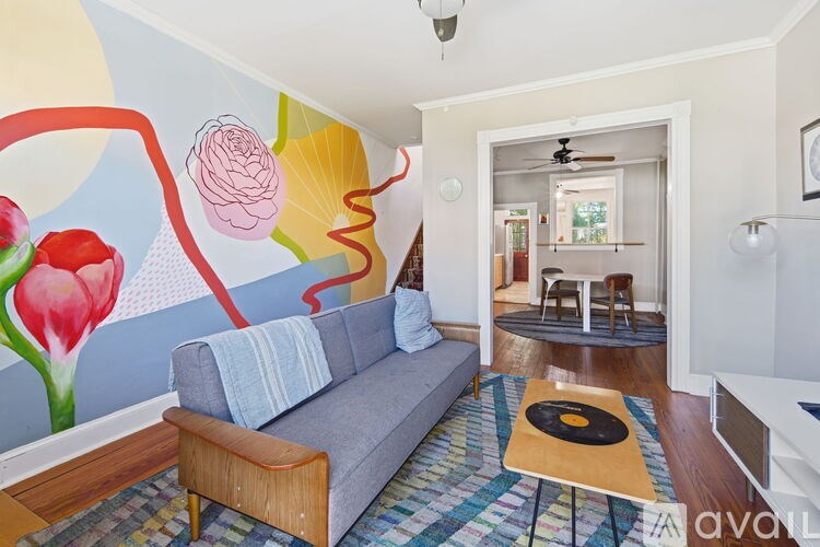 A black shelf with a bowl of oranges on top of a table.