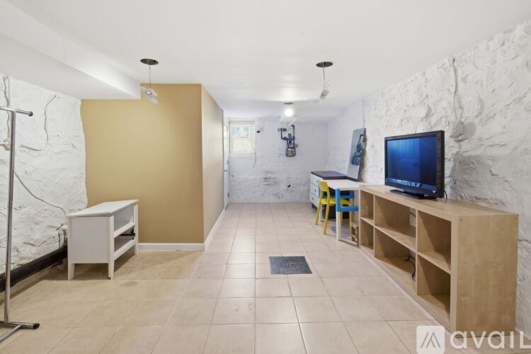 A white toilet with a blue and black patterned shower curtain.