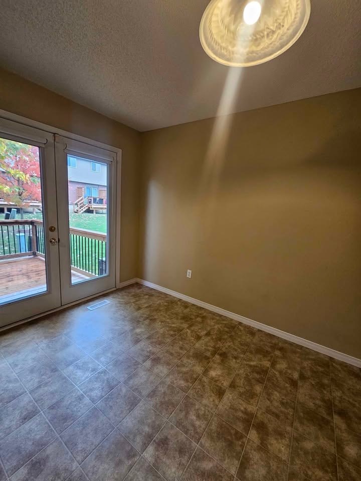 A room with a sliding glass door leading to a balcony.