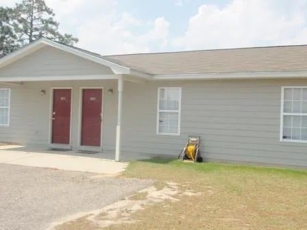 A house with a red door and a small porch.