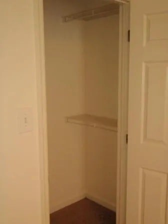 A white door with a shelf in the middle.