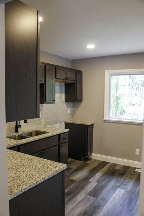 A kitchen with a sink and a window.