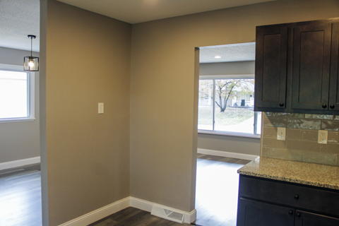 A kitchen area with a counter and cabinets.