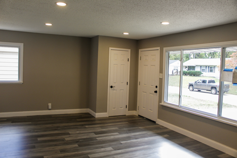 A room with two doors and a window.