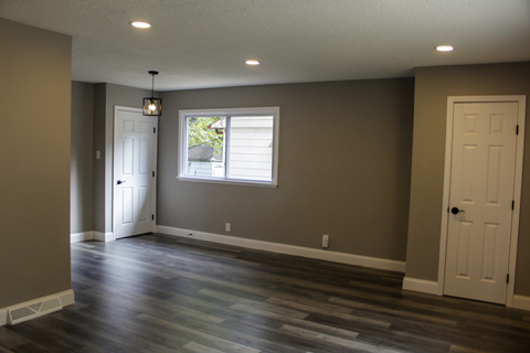 A room with a window and a door.