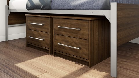 A bed with a white headboard and a wooden dresser underneath it.