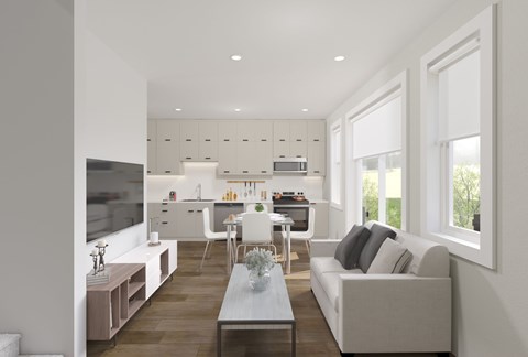 A modern living room with a grey couch and a wooden floor.