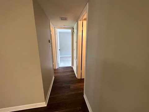 A long hallway with a door at the end.