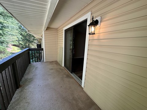 A porch with a light on the wall.