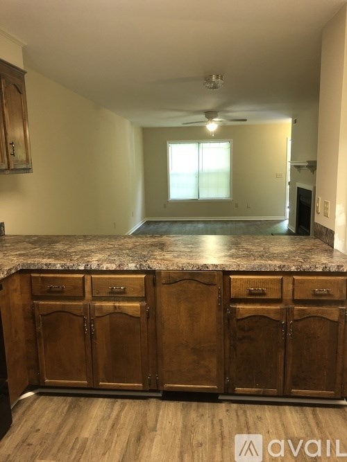 A kitchen with wooden cabinets and a granite countertop.