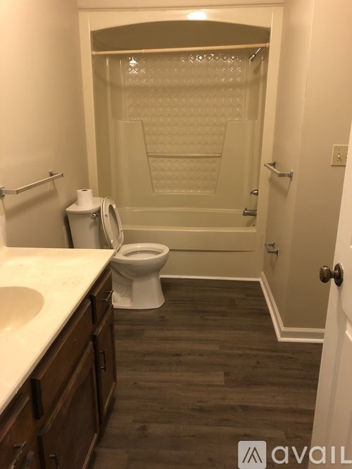 A bathroom with a toilet, sink, and walk-in shower.