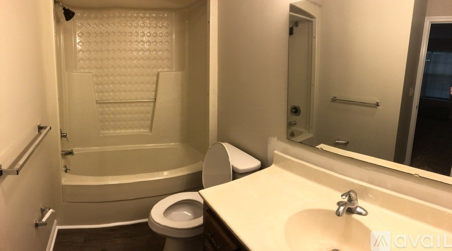 A bathroom with a toilet, sink, and bathtub.