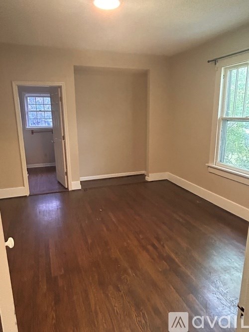 A room with wooden floors and a window.