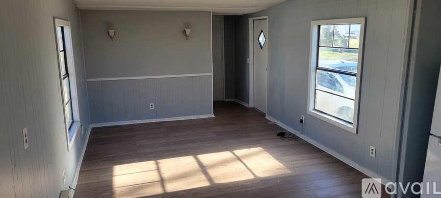 A room with wooden floors and grey walls.
