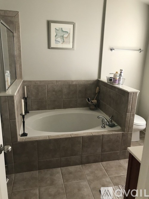 A bathroom with a tub, toilet and sink.