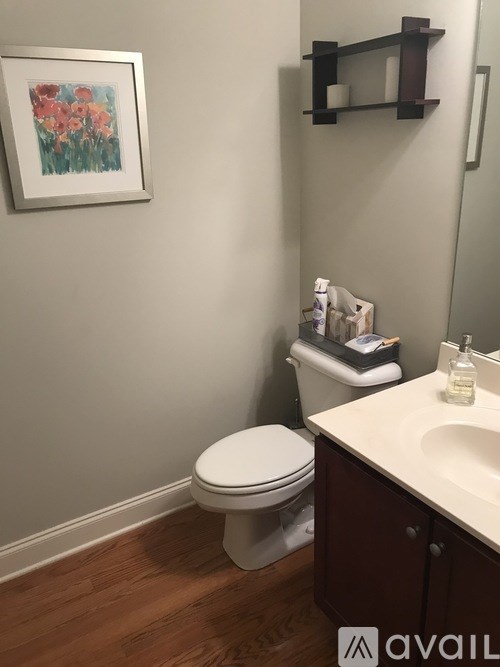 A white toilet sits next to a sink in a bathroom.