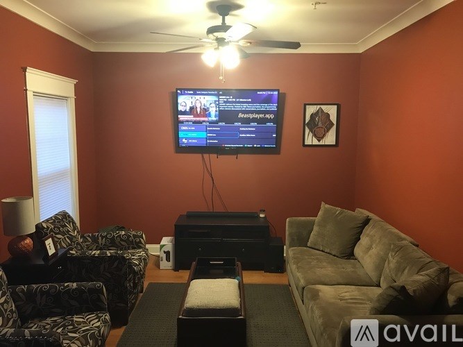 A living room with a television displaying a game on the screen.