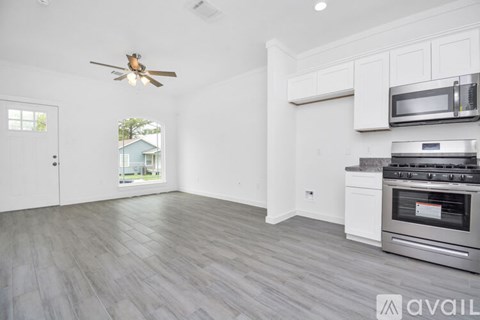 A kitchen with a stove top oven and microwave above it.