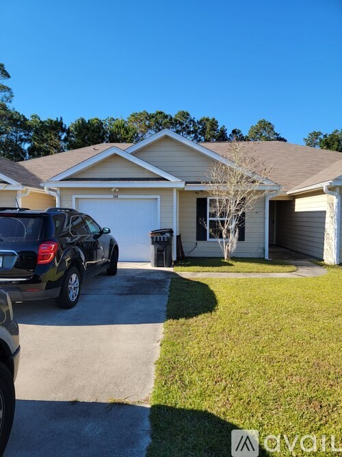 A house with a car parked in front of it.
