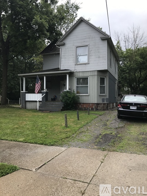 A house with a car parked in front of it.