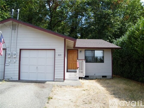 A house with a garage and a flag on the left side.