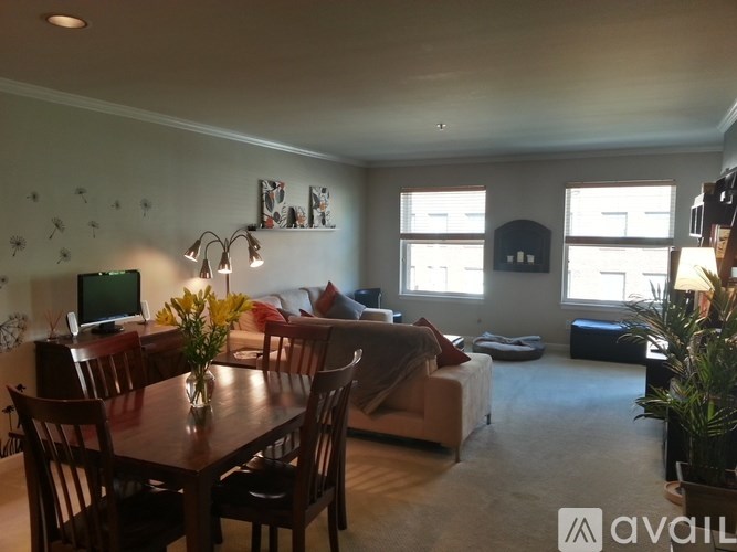 A living room with a dining table and chairs.