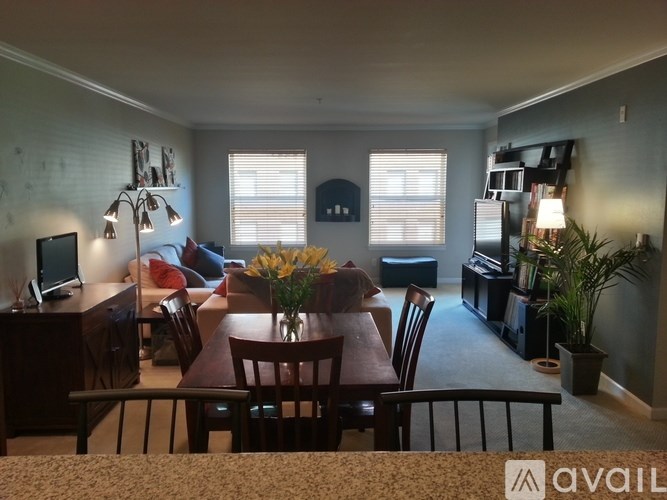 A living room with a dining table and chairs.