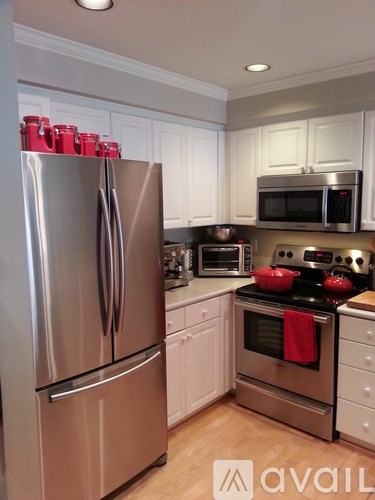 A kitchen with a stainless steel refrigerator and oven.