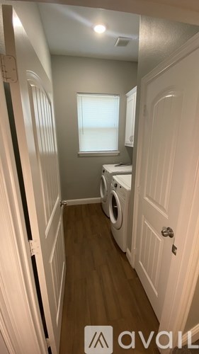 A small laundry room with a washer and dryer.