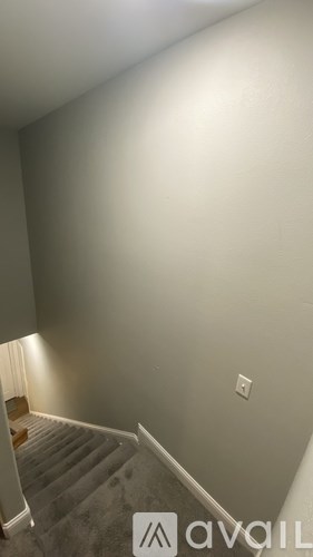 A staircase with a light on the side.