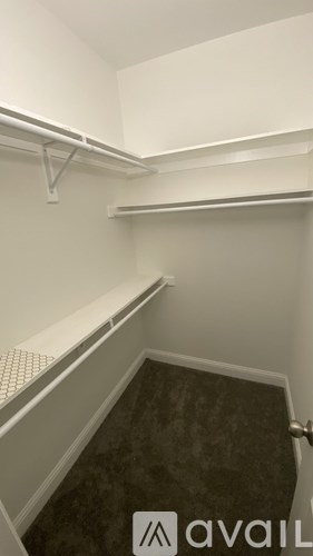 A small, empty room with a carpeted floor and white walls.