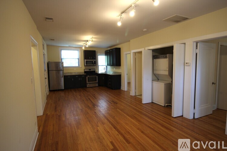 A kitchen with wooden floors and white appliances.