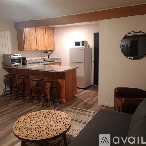 A kitchen with wooden cabinets and a white refrigerator.