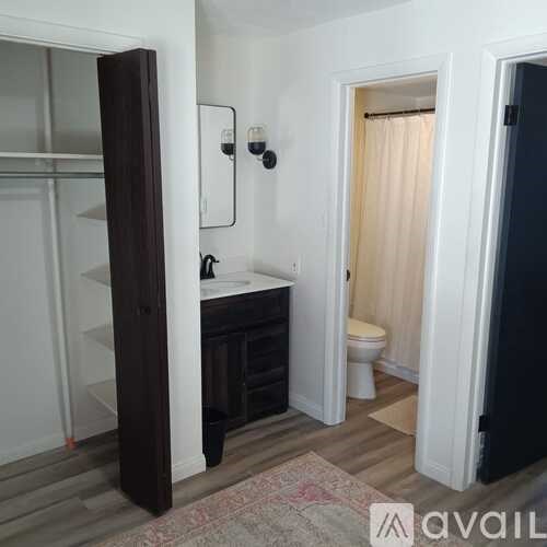 A bathroom with a sink, toilet, and a shower with a glass door.