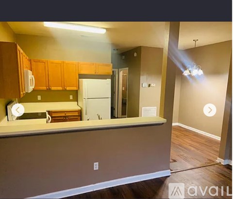 A kitchen with wooden cabinets and a white refrigerator.