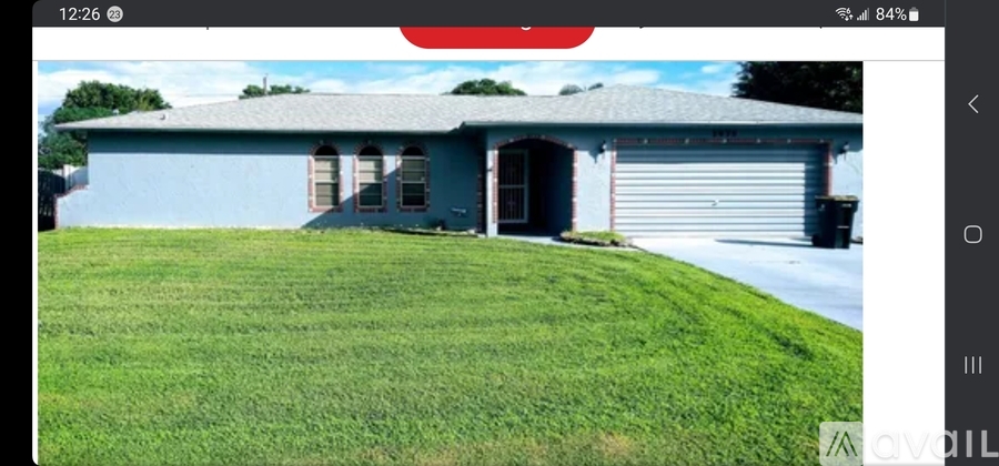 A blue house with a white garage door.