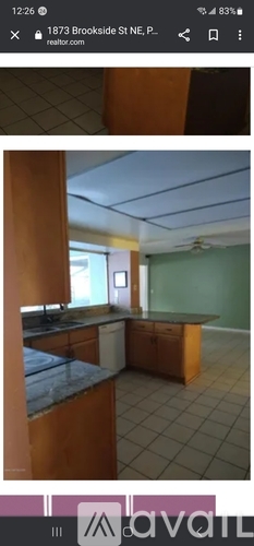 A kitchen with wooden cabinets and a tiled floor.