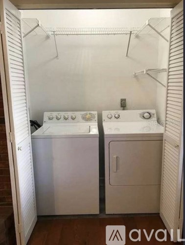 A small laundry room with a washer and dryer.