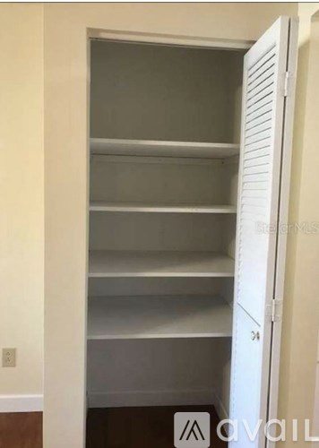 Empty white shelves in a pantry.