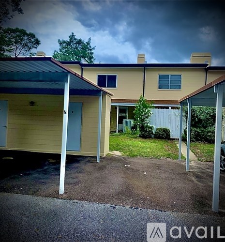 A house with a blue door and a carport.