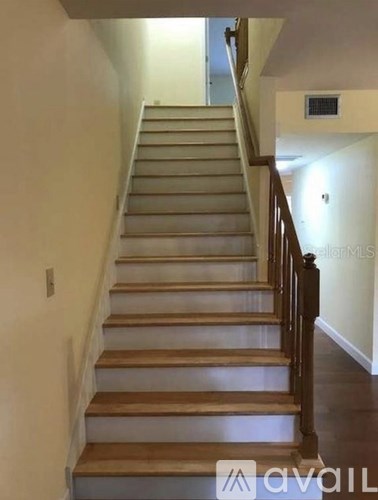 A staircase with wooden steps and a dark balustrade.