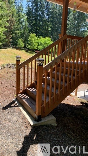A wooden staircase with a railing and lights on top.