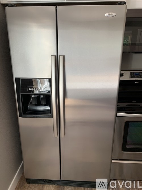 A stainless steel refrigerator with its door open.