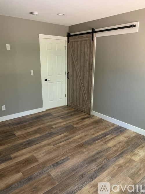 A room with a white door and a sliding door.