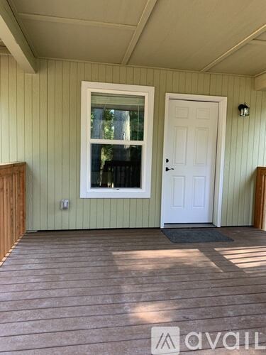 A white door is on the right side of a window.