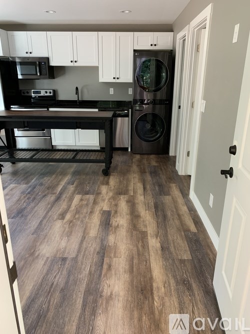 A kitchen with a washer and dryer built into the cabinetry.