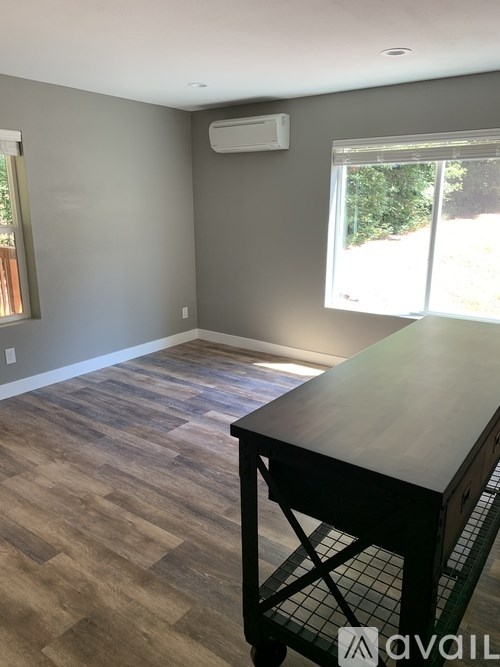 A room with a wooden floor and a table in it.