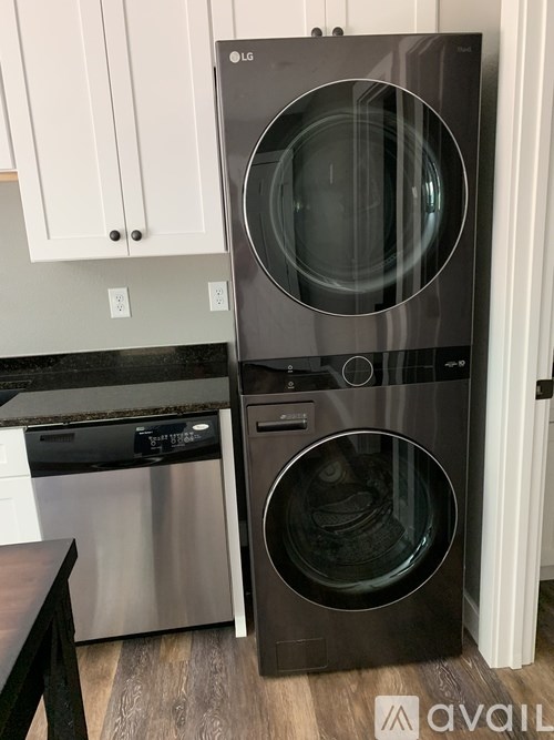 A black LG washing machine and dryer in a kitchen.